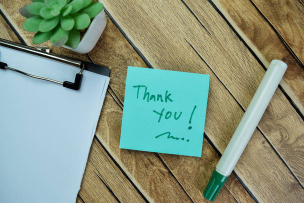 Concept of Thank You write on sticky notes isolated on Wooden Table. - Foto, Imagen