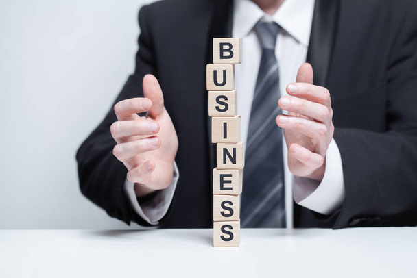 Tower of wooden blocks with black word business. Abstract business, company, growth concept - Photo, Image
