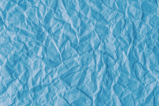 Gerecycled verfrommeld blauw papier textuur achtergrond. Gerimpelde en gerimpelde abstracte achtergrond, behang met kopieerruimte, bovenaanzicht. - Foto, afbeelding