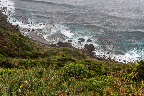 Wild Atlantic Ocean with small stone beach and wawes in Madeira - View from Vereda do Larano trail between Porto da Cruz and Canical - Photo, Image