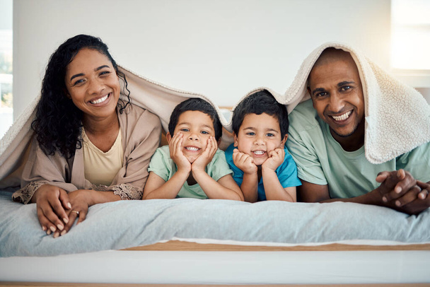 Happy family, morning bed portrait and relax mother, father and children smiling, home bonding and enjoy time quality together. Comfort, love smile and cozy man, woman and youth kids lying in bedroom. - Photo, Image