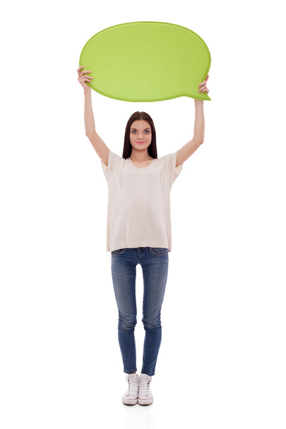 Portrait of a casual young woman holding blank card - over white background. - Foto, imagen