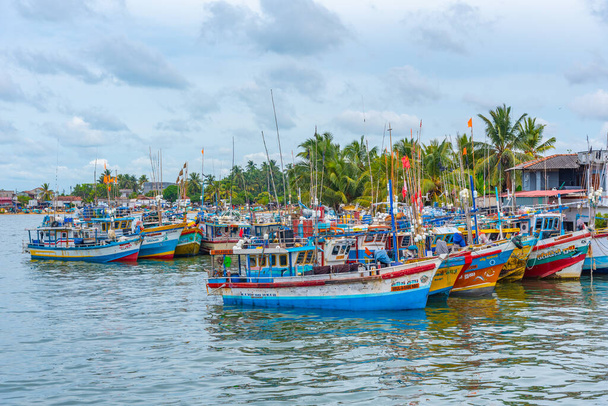 Negombo, Sri Lanka, February 13, 2022: Fishing boats mooring at the shore of Negombo lagoon in Sri Lanka. - Photo, Image