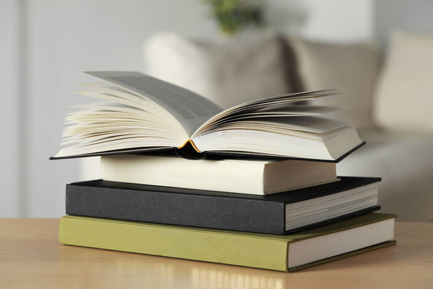 Stack of hardcover books on wooden table indoors, closeup - Photo, image