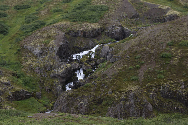 Waterfall along the highway west of Reydarfjodur, Iceland  - Fotografie, Obrázek