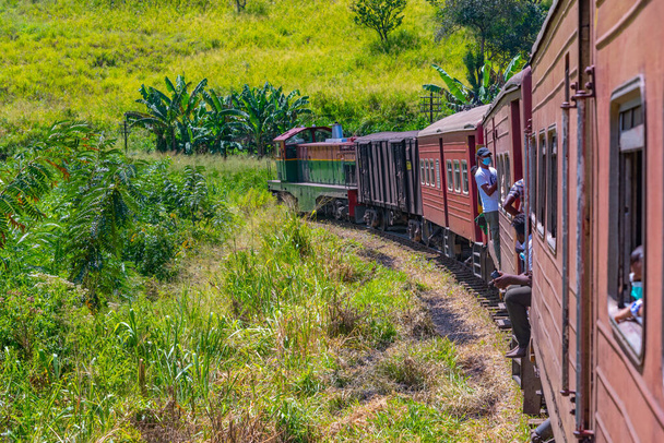 Ella, Sri Lanka, January 29, 2022: Train winding on a hillside track among tea plantations at Sri Lanka. - Fotografie, Obrázek