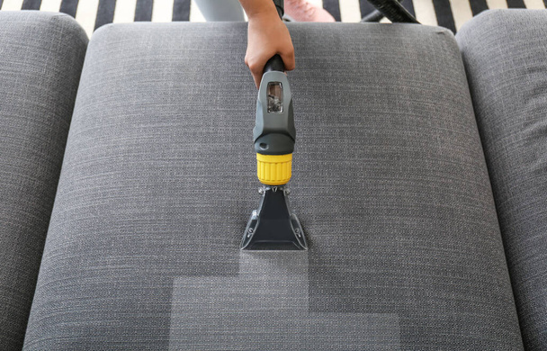 Woman removing dirt from sofa at home, top view - Photo, Image