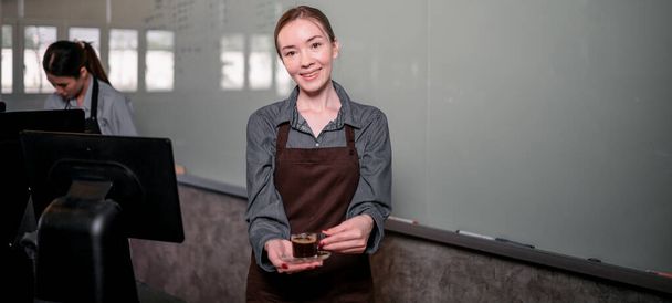 Young adult baristas follow recipes to create artisan and specialty beverages. Making drip coffee with a unique way. Small business owners practice the sense of taste and scent at slow bar coffee. - Фото, зображення