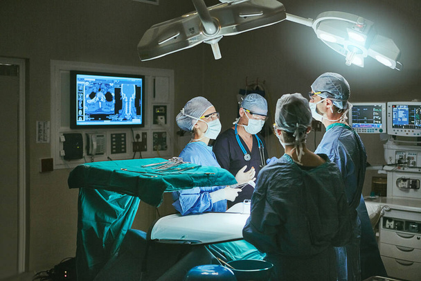 Undergoing surgical treatment. surgeons in an operating room - Photo, image