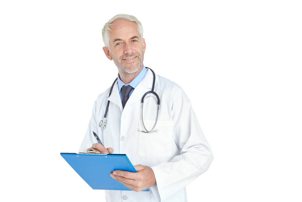 He knows whats best for you. Portrait of a handsome mature male doctor standing with a medical chart against a white background - Photo, image