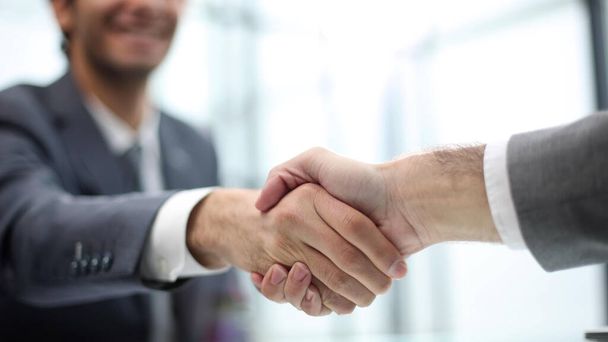 Young business people shaking hands in the office. Finishing successful meeting. - 写真・画像