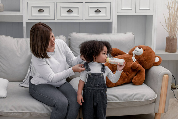 Children learn from parents how to walk, hold things, take turns, play symbolic toys, and express emotions. Getting love, guidance, inspiration, and protection. Building character and personality. - Photo, image