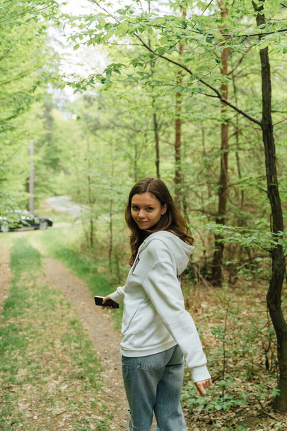 teenager gen z girl walking in the forest. close to nature concept. High quality photo - Foto, Imagen