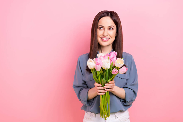 Photo of young girl wear casual outfit receiving bouquet fresh tulips flowers international woman day dreamy isolated on pink color background. - Photo, Image
