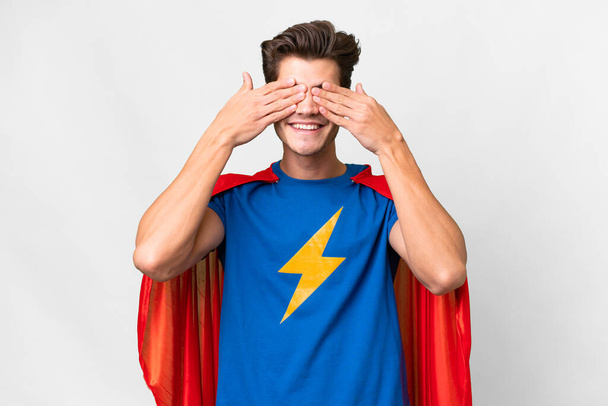 Super Hero caucasian man over isolated white background covering eyes by hands - Фото, зображення