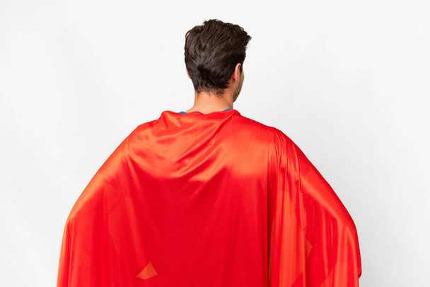Super Hero caucasian man over isolated white background in back position - Foto, Bild