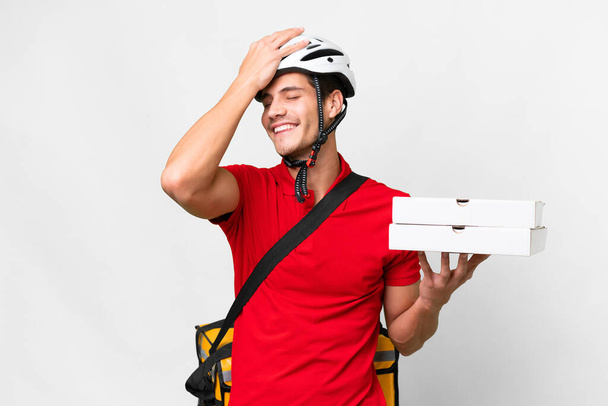 Pizza delivery man with work uniform picking up pizza boxes over isolated white background has realized something and intending the solution - Zdjęcie, obraz