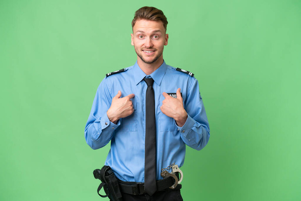 Young police man over isolated background with surprise facial expression - Photo, Image