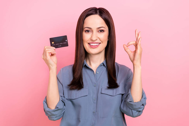 Photo of charming funny lady wear trendy grey clothes okey symbol hold debit card successful transaction isolated on pink color background. - Fotoğraf, Görsel