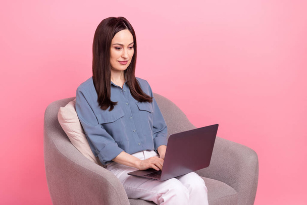 Photo portrait of professional marketer web designer woman sitting armchair use new apple macbook pro gadget isolated on pink color background. - Foto, Imagem