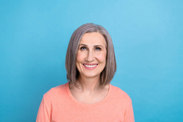 Portrait of senior lady gray hair wear shirt looking satisfied up empty space proposition new job offer website isolated on blue color background. - Photo, Image