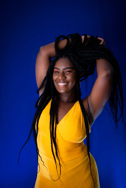 Portrait of beautiful young woman smiling at camera. Isolated on blue background. - Fotó, kép