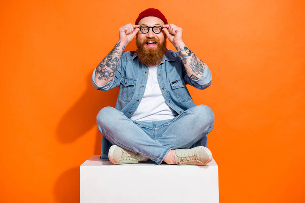Photo of positive guy impressed incredible shopping promotion touch his specs isolated bright color background. - Foto, Bild