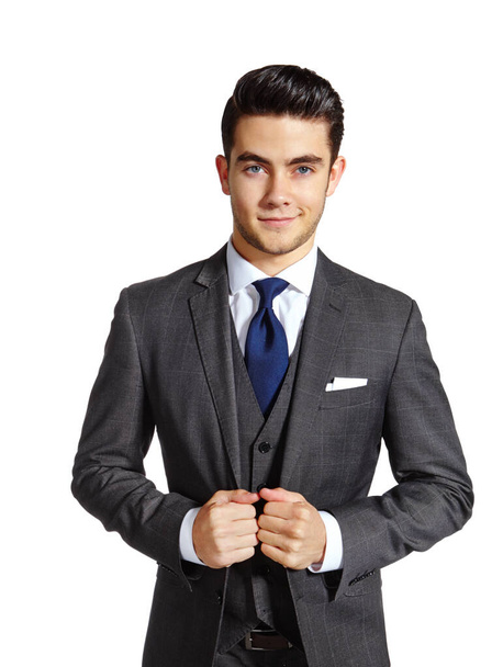 Ready to take on the corporate world. A handsome young man in a three piece suit standing against a white background - Fotó, kép