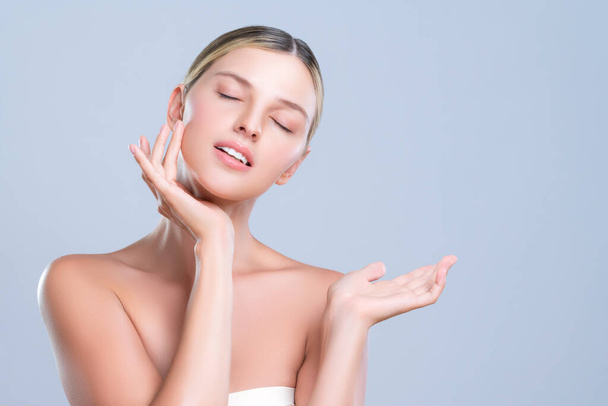 Alluring beautiful woman with perfect smooth and clean skin portrait in isolated background. Beauty hand gesture with expressive facial expression for skincare treatment product or spa. - Φωτογραφία, εικόνα
