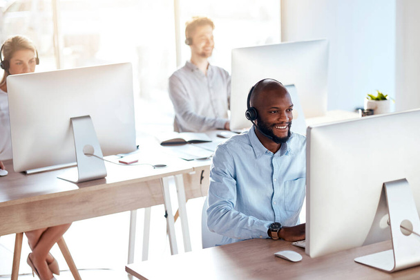 Call center, computer and consulting with black man in office for customer service, technical support and advice. Technology, contact us and communication with employee operator in help desk agency. - Foto, Imagen