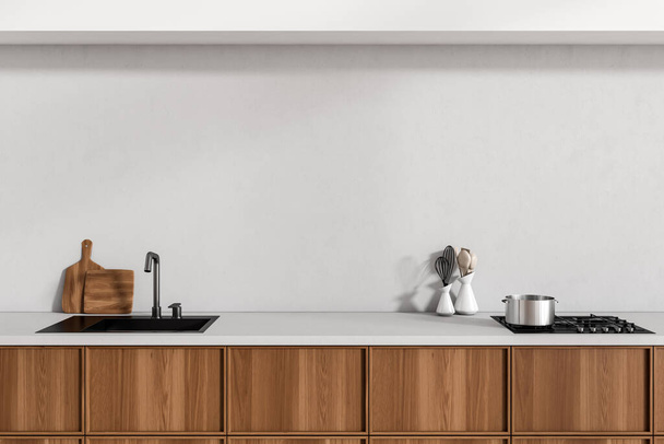 Close up view on bright kitchen room interior with cupboard, white empty wall, sink, gas cooker, spoon, cooking desks. Concept of minimalist design. 3d rendering - Foto, Bild