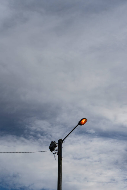 Street lighting lantern with cloudy sky in the background - Fotó, kép