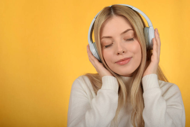 young pretty woman enjoying music in headphones - Фото, зображення
