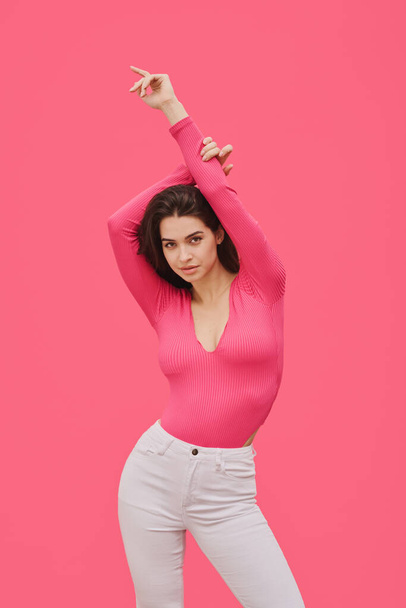 Portrait of sexuality young girl in pink blouse posing at camera against pink background - Fotoğraf, Görsel