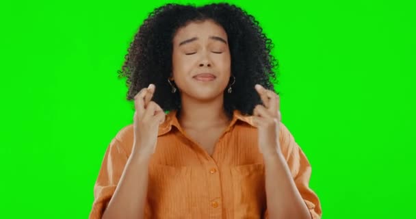 Green screen, hope and woman with fingers crossed, luck and praying against a studio background. Female, believer or desperate person with gesture for wish, nervous and worried, with miracle and fear. - Felvétel, videó