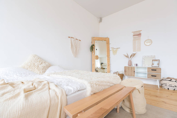 cute cozy light interior design of the apartment with a free layout of the kitchen and bedroom areas. a lot of windows, a wooden floor and a hanging swing. - 写真・画像