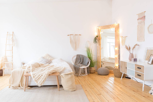 cute cozy light interior design of the apartment with a free layout of the kitchen and bedroom areas. a lot of windows, a wooden floor and a hanging swing. - Фото, изображение