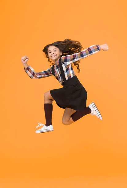 Feel inner energy. Girl with long hair jumping on yellow background. Carefree kid summer holiday. Time for fun. Active girl feel freedom. Fun and jump. Happy childrens day. Jump concept. Break into. - Fotografie, Obrázek