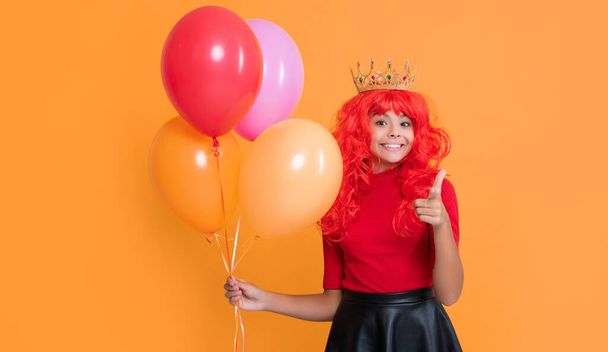happy child in crown with party balloon on yellow background. - Фото, зображення