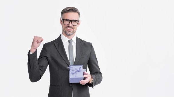 successful mature man in eyeglasses and suit hold present box isolated on white background. - Foto, imagen