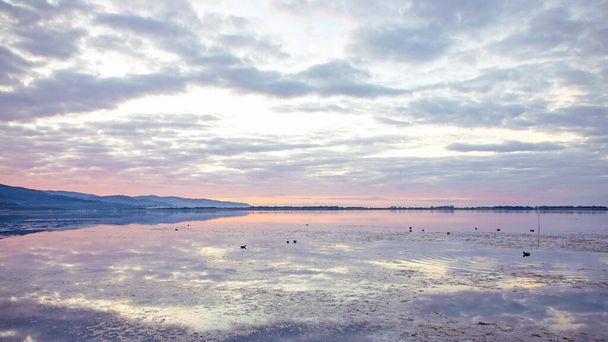 landscape of Orbetello Lagoon at sunset,  the most important lagoon of the Tiyrrhenian sea and natural reserve in the Grosseto province, Tuscany, Italy - Photo, Image