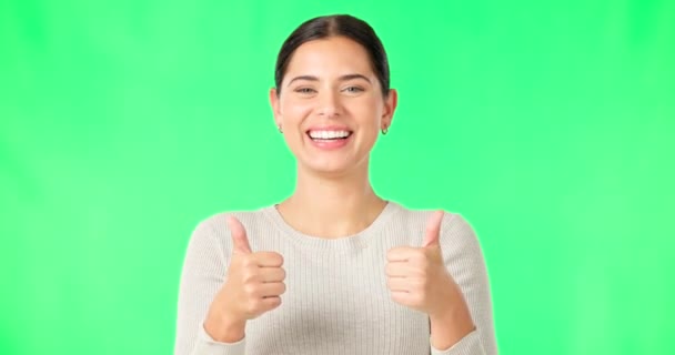 Happy woman, hands and thumbs up on green screen for agreement, good job or winning against a studio background. Portrait of female smile showing thumb emoji, yes sign or like for success on mockup. - Footage, Video