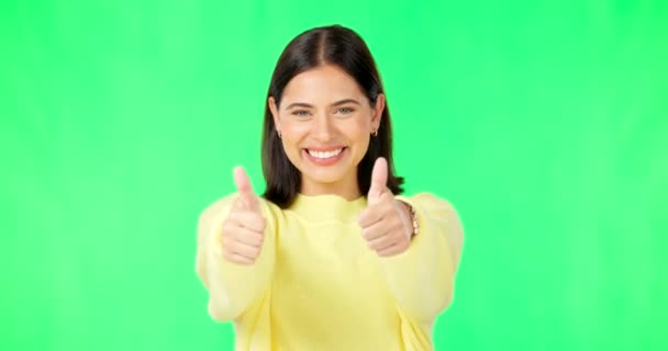 Happy woman, hands and thumbs up on green screen for winning, success or agreement against a studio background. Portrait of female with smile showing thumb emoji, yes sign or like on chromakey mockup. - Footage, Video