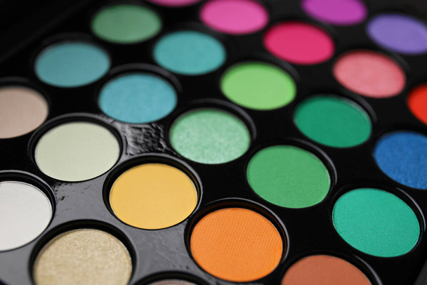 Beautiful eyeshadow palette as background, closeup. Professional cosmetic product - 写真・画像