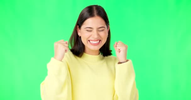 Happy woman, celebration and fists on green screen for winning, success or promotion against a studio background. Portrait of excited female winner smiling in joy for win or bonus on chromakey mockup. - Footage, Video