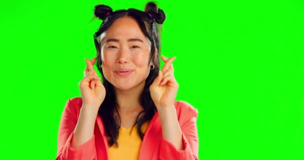 Happy woman, fingers crossed and face in studio, background and green screen for good luck. Portrait of excited asian female hope for wish, winning vote and lucky lottery prize with emoji hands sign. - Footage, Video