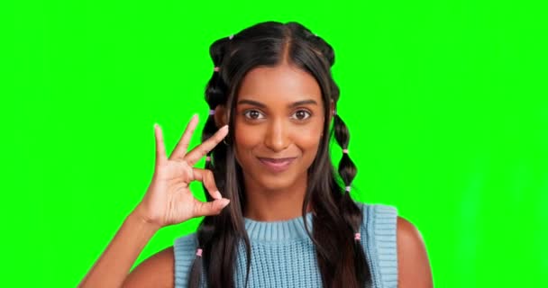 Woman, ok hand and smile in green screen studio with excited face, motivation and mock up for success. Girl, student and model with sign, icon or emoji for portrait with review, opinion and thank you. - Footage, Video