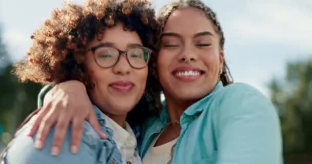 Friends, sisters and portrait of black women hugging outside with smile, happiness and solidarity in love and pride. Lesbian couple, woman and friend in happy embrace for support and trust together - Footage, Video