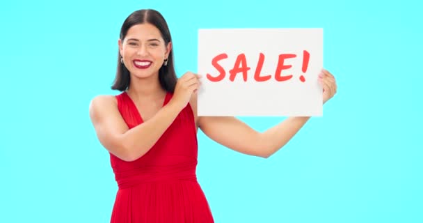 Woman holding sale poster isolated on blue background for retail, shopping or customer discount announcement. Happy face of person with fashion promotion, deal or cardboard sign in studio advertising. - Footage, Video