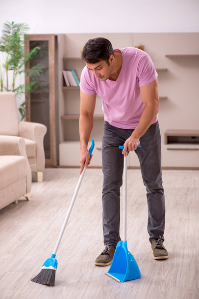Young contractor cleaning the house - 写真・画像